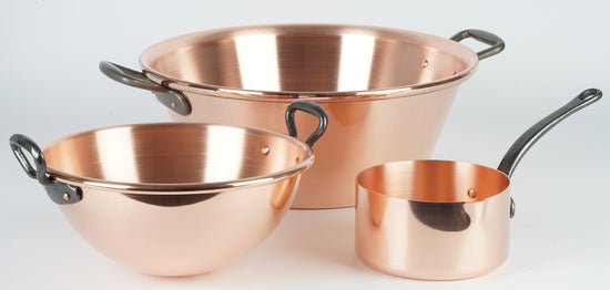 Why must copper pans be lined with a tin coating on the interior?